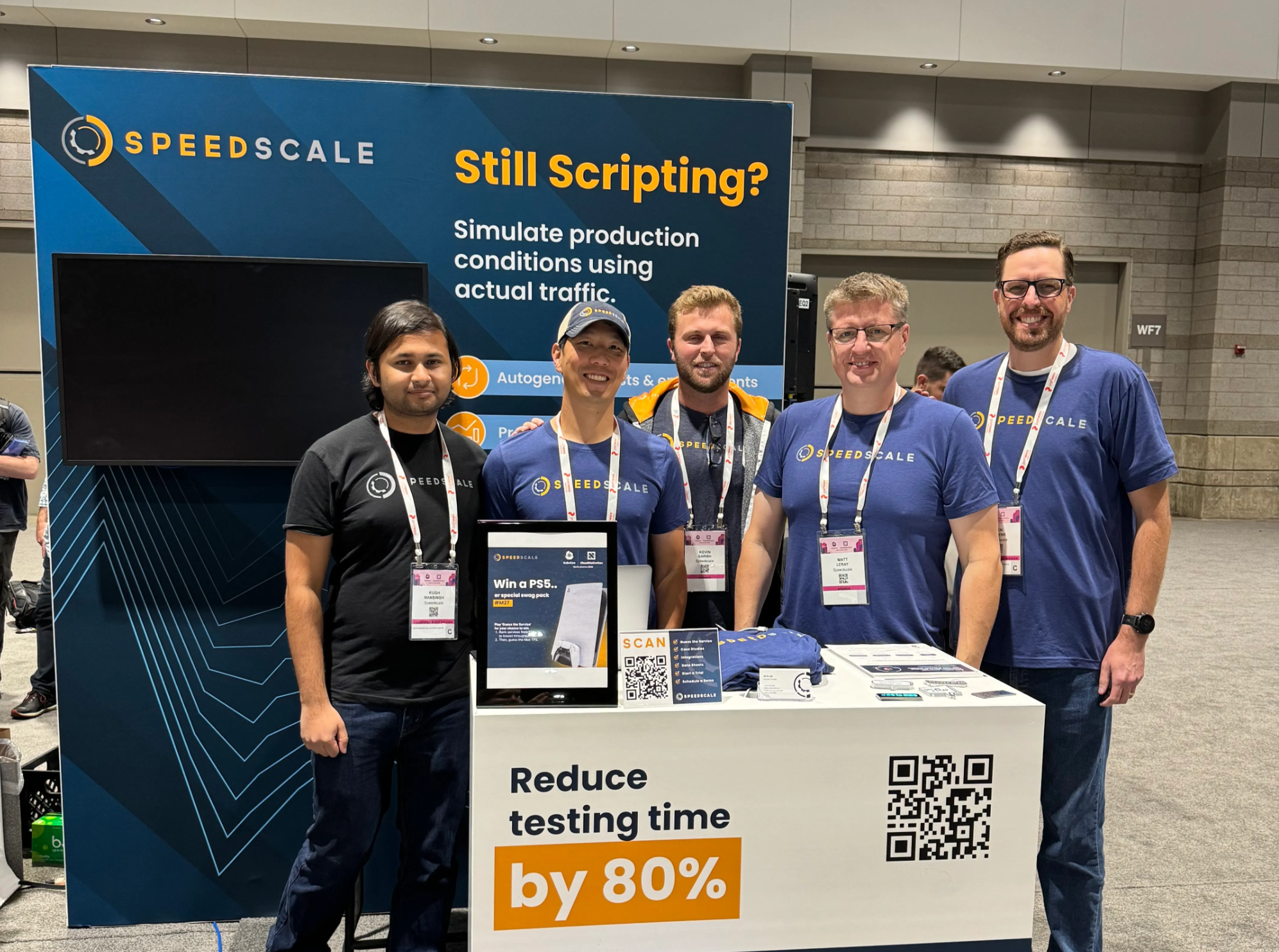 Speedscale team at a previous conference booth smiling in front of the display.